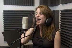 Woman singing in a recording studio